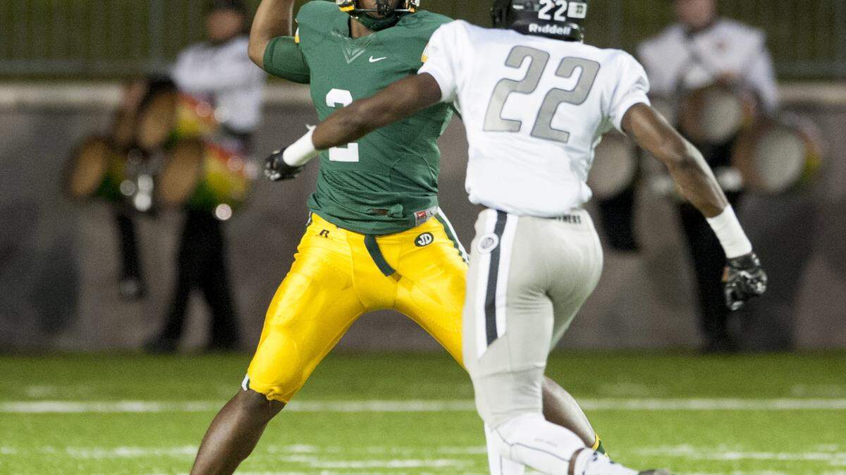 Jeff Davis quarterback Zarron Haney throws over Smiths Station's Phatavious Wimberly (22) at Cramton Bowl in Montgomery, Ala. on Thursday October 8, 2015.