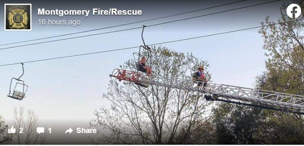 A photo shows a firefighter carrying a child down the ladder.