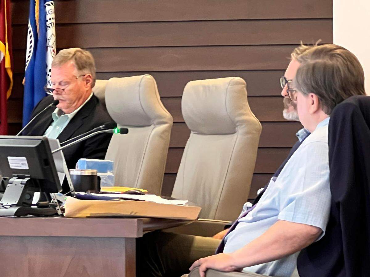 During the July 8, 2025, Columbus Council meeting, City Attorney Clifton Fay, right, and Councilor Glenn Davis of District 2 debate whether a grievance should be filed over “excessive fees” after the the Columbus Consolidated Government paid CCG human resources director Reather Hollowell’s legal costs following an investigation into the CCG finance department. 