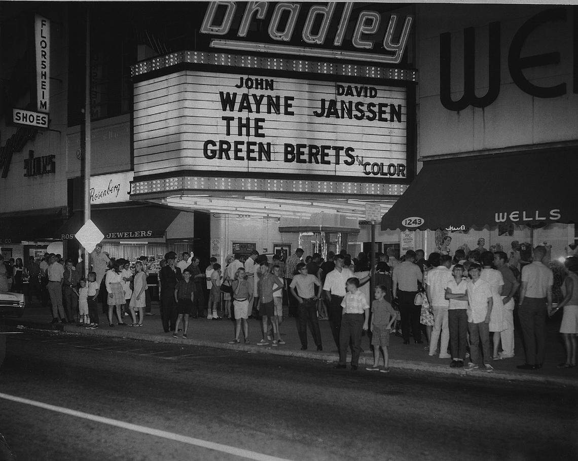 People wait in line outside the Bradley Theater in downtown Columbus, GA, to watch a showing of “Green Berets.”