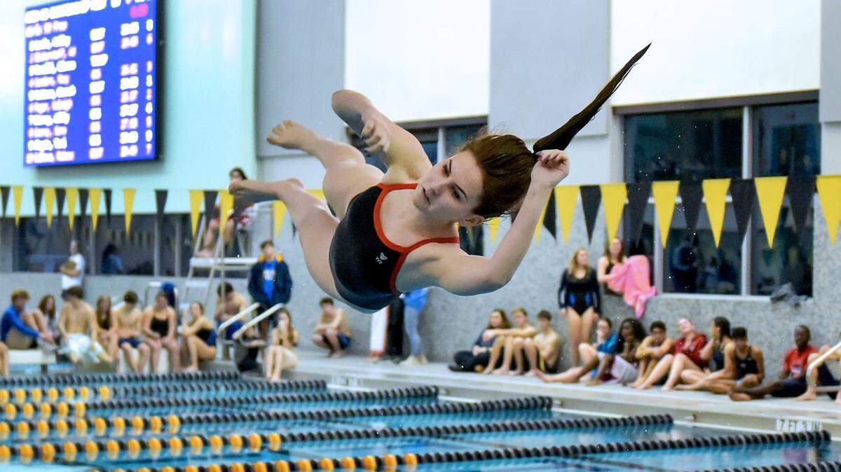 Olivia Hinton of Columbus High executes a front flip half twist dive during the Regional Area Championships Meet in the Columbus Aquatic Center on Tuesday January 22, 2019.