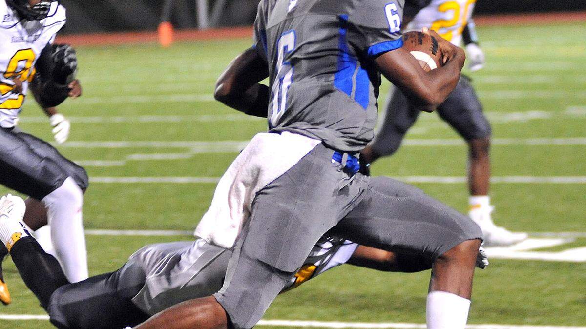Columbus' Derrick James runs through the tackle of Harris County's Tahsaan Tucker on a drive that started at the 5 yard line and went 95 yards and 15 plays for Columbus 2nd touch down of the night