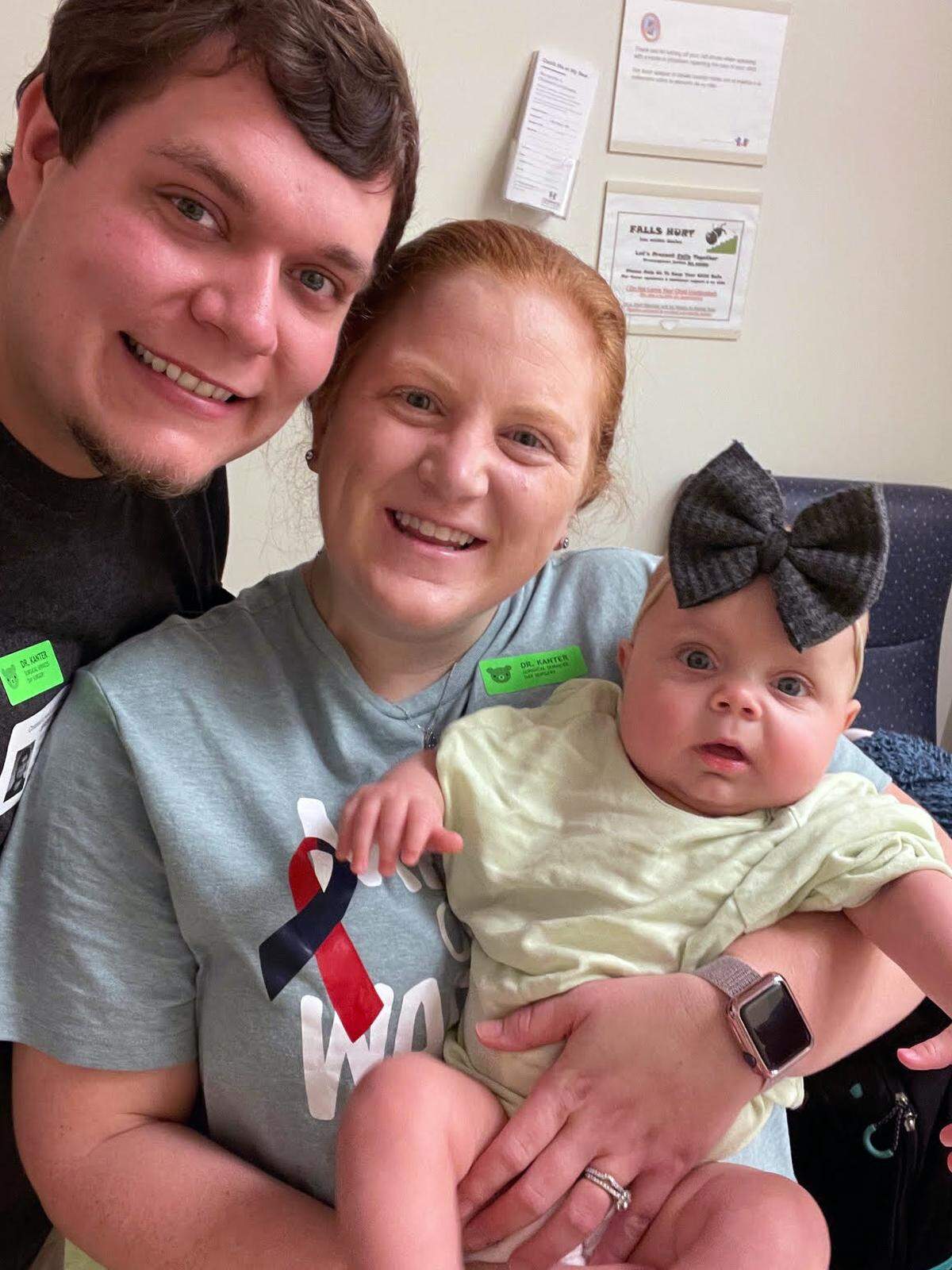 Jeremy and Summer Head hold their daughter Ansley Head.