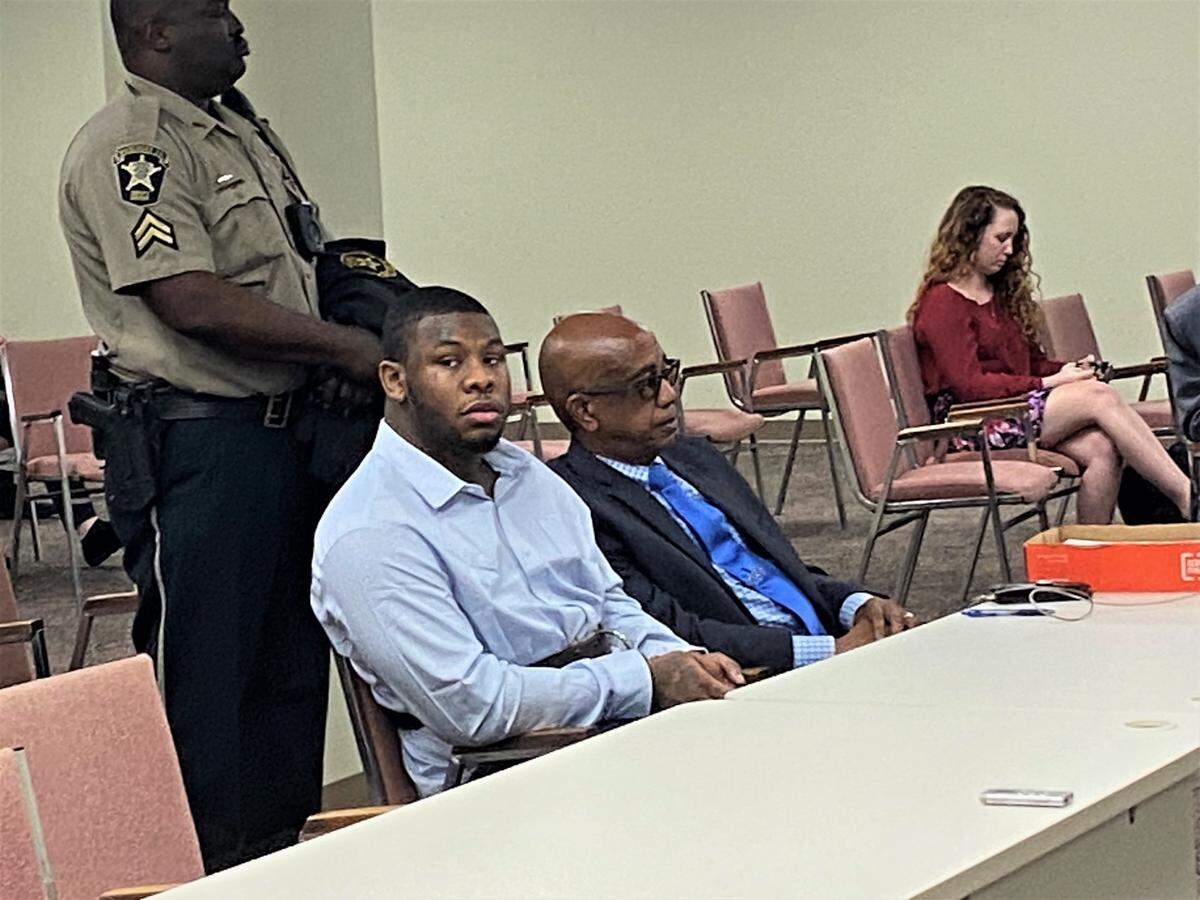 Trevonius Tyriq Williams, left, sits with defense attorney Shevon Thomas after pleading guilty to shooting Cross Henderson during a 2020 Columbus home invasion.