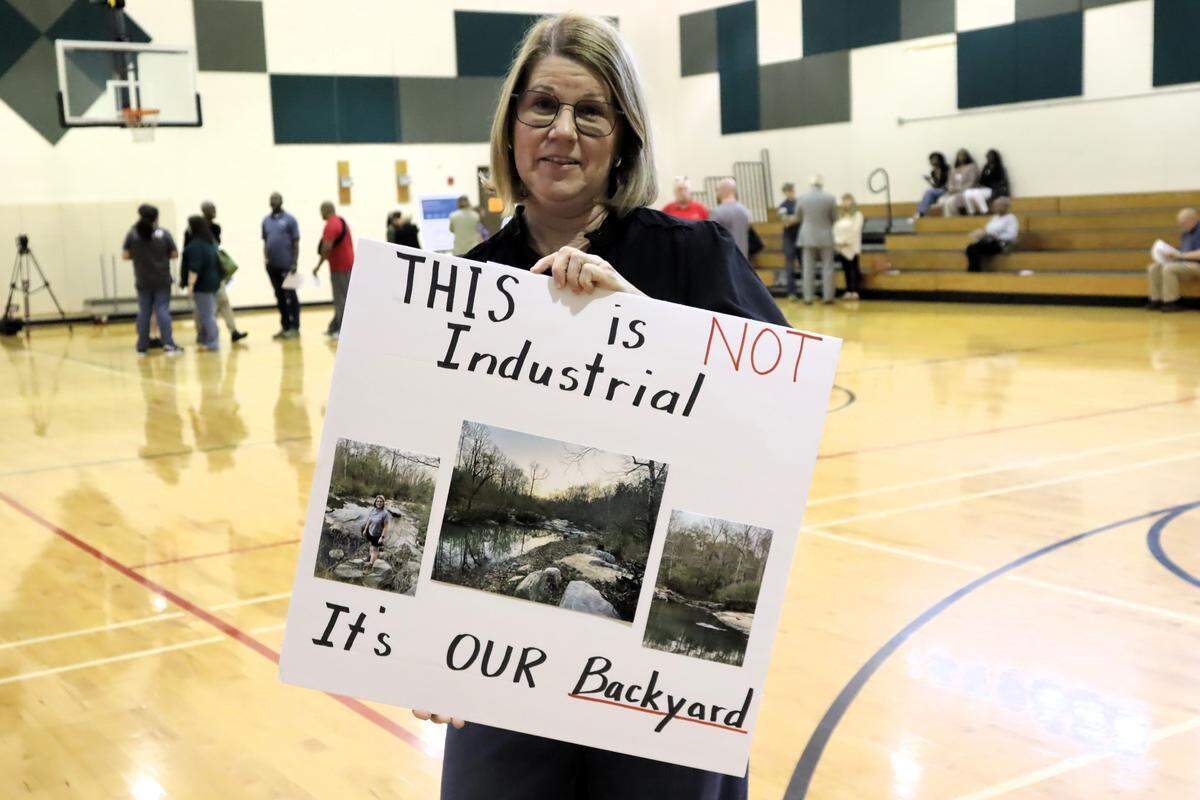 During a forum March 23, 2026, at the Psalmond Road Recreation Center in Columbus, a woman holds a sign opposing development where she lives off McKee Road, bordering the site for Project Ruby, a proposed hyperscale data center.