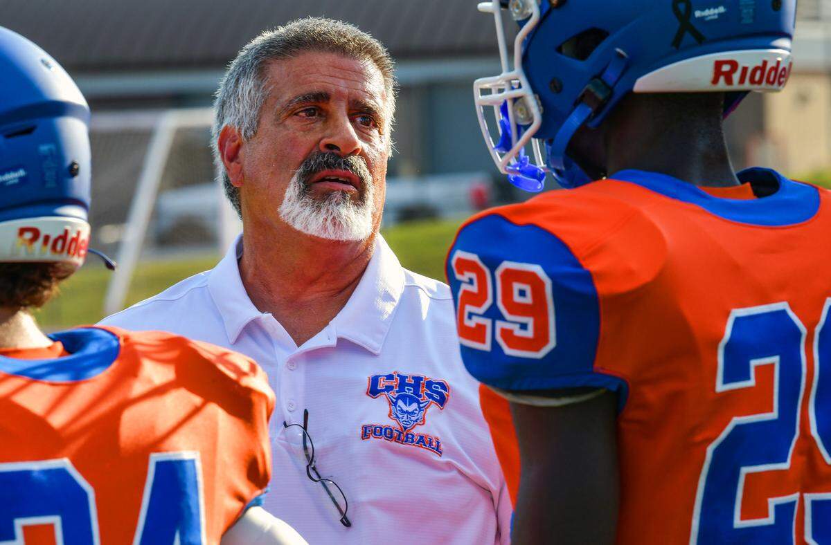 Phil Marino, head football coach at Columbus High School, talks with one of his players during the Blue Devils’ game Aug. 18, 2023.