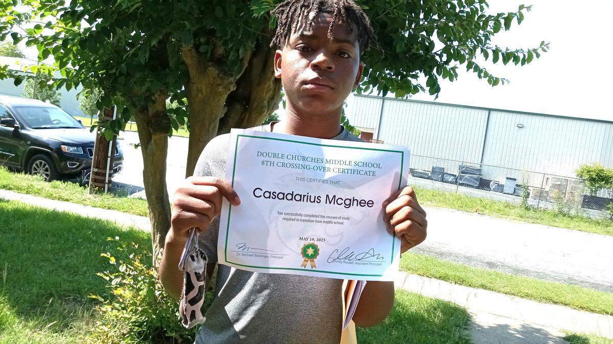 Casadarius McGhee poses with his certificate showing he graduated from Double Churches Middle School in the spring of 2023.