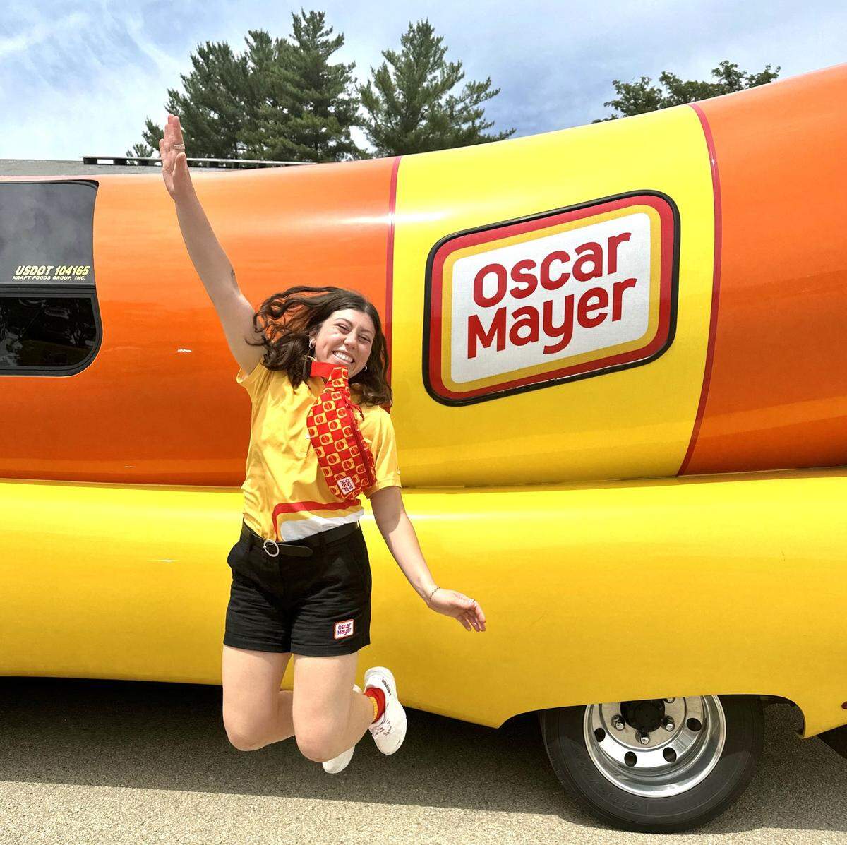 Columbus native Sarah Oney, one of 12 Wienermobile drivers Oscar Mayer selected for the 2024-25 season from more than 7,000 applications, jumps for joy during a practice event June 2024 in Darlington, Wisconsin.