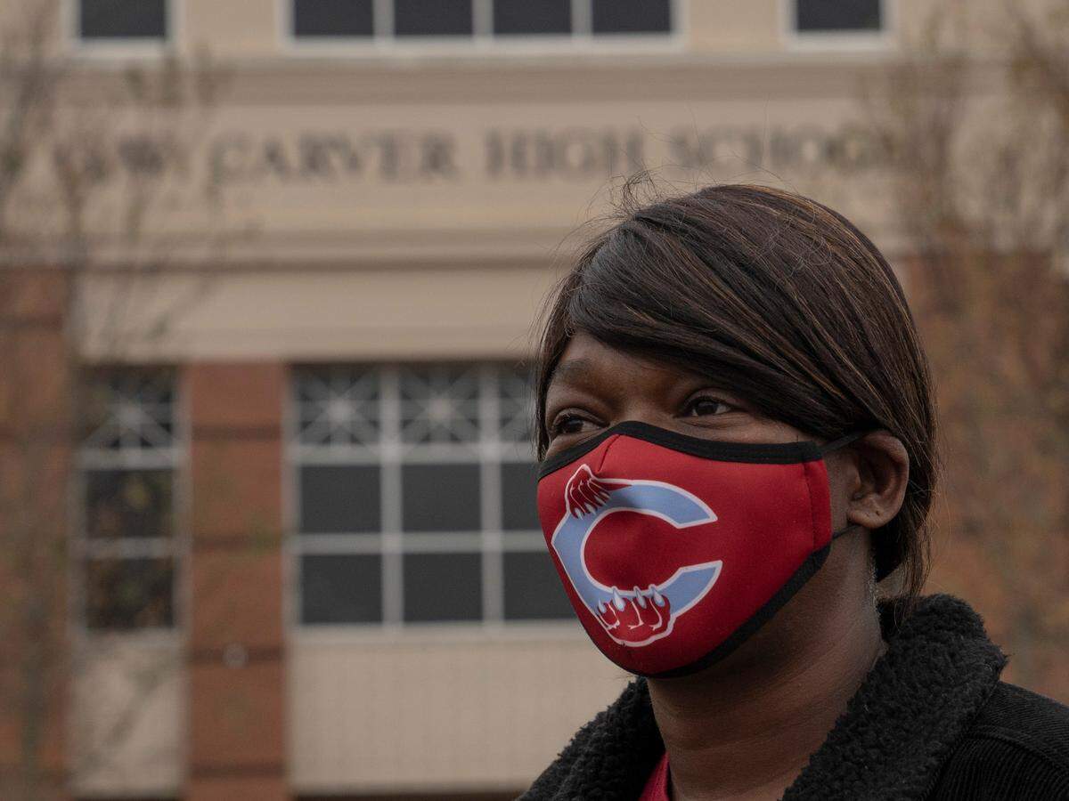 Tonza Thomas poses for a portrait at her alma mater Carver High School in Columbus, Ga, on Dec. 4, 2020. At the high school, she hosted a voter registration drive during a volleyball game.