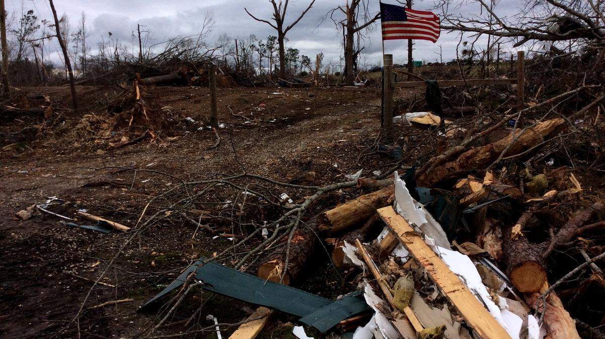 A flag flies at the gate to storm-wrecked property off Alabama 51 in Beauregard, Ala., where a tornado hit March 3.