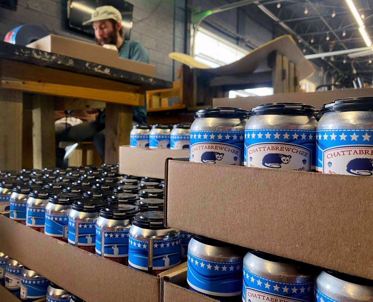 Workers at Chattabrewchee Southern Brewhouse in Columbus, Georgia label nearly 1,000 cans of Chattabrewchee’s Lazy River Lager. 02/28/2024