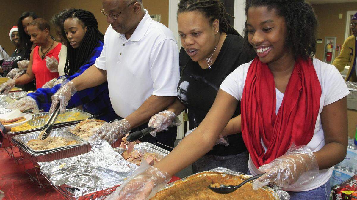 Mike Haskey mhaskey@ledger-enquirer.com 
 Volunteers serve Christmas dinner Friday afternoon in the Liberty Theatre during a Christmas party for people who lost their homes because of a fire earlier this week at Boulevard Apartments in Columbus. 12/25/15