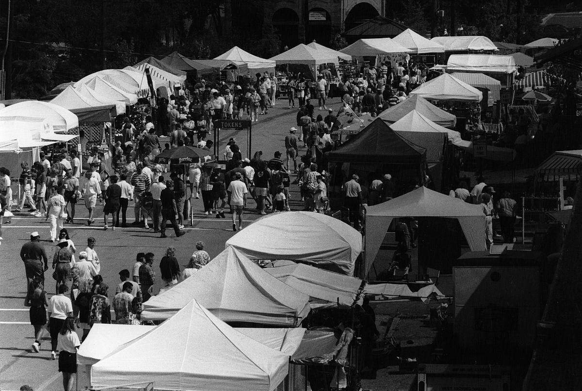 People walk through the arts and crafts area at Riverfest.