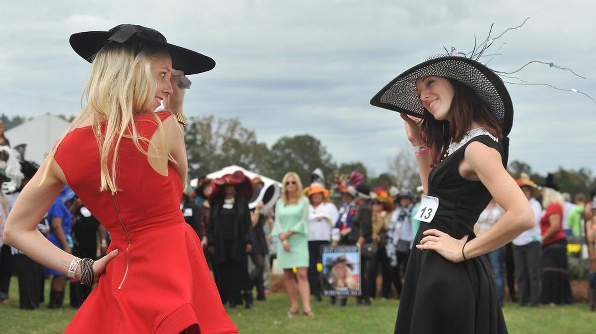 Claire Tkalych and Jesse Cody model their hats during the Southern Views Magazine Hat Contest at the SteepleChase at Callaway Gardens on Nov. 7, 2015.