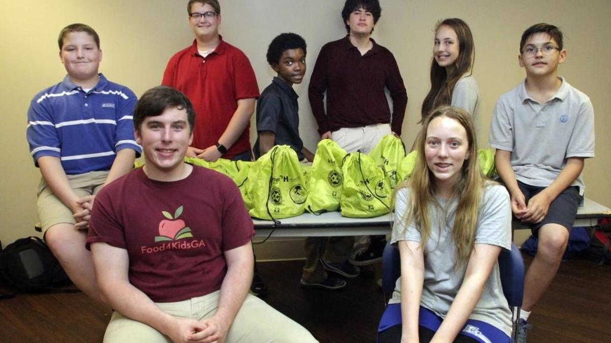 21st Century Leaders, a Georgia-based nonprofit youth leadership and talent development organization, selected Brookstone senior Jack Henslee, front left, as one of the state's Top 20 Under 20 among the 2016 Georgia Youth Leadership Awards. Jack was honored for the positive impact he has made through founding the Georgia chapter of Food4KidsUSA, which provides impoverished children a backpack full of food for the weekend. Brookstone students help fill the food backpacks for local children. Back row, from left: Mason Dudley, 9th grade; his brother Jack Dudley, 12th grade; Shaun Price, 7th grade; Rob Simkins, 11th grade; Parker Reed, 7th grade and Patrick Reed, 5th grade. Seated front: Henselee, left, and his sister Kathleen Henslee, 7th grade.