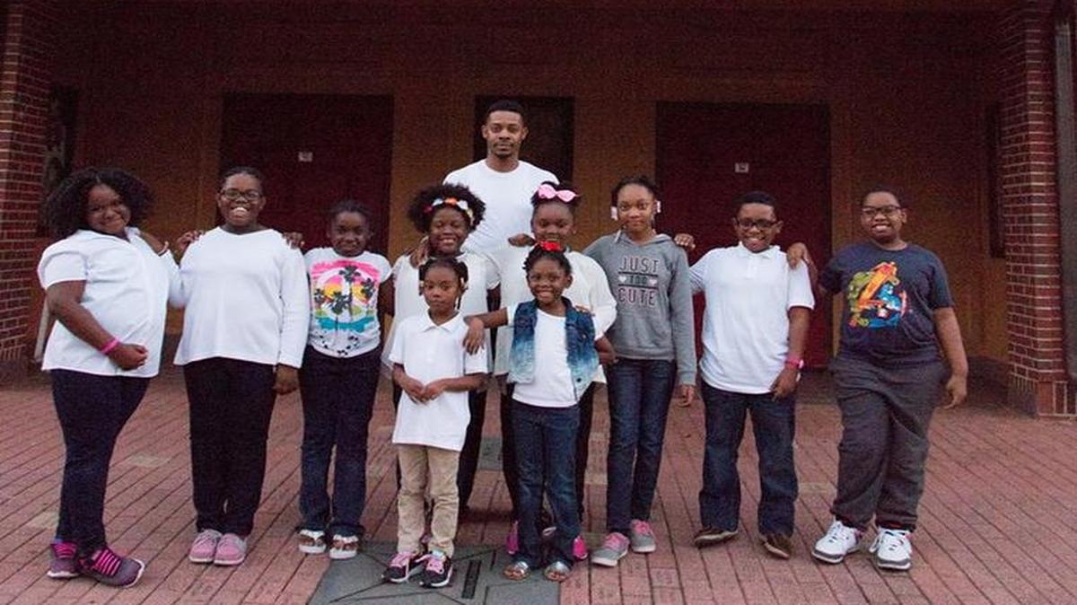 Students pose at the Liberty Theatre. The Theatre is launching a new arts immersion initiative for young men.