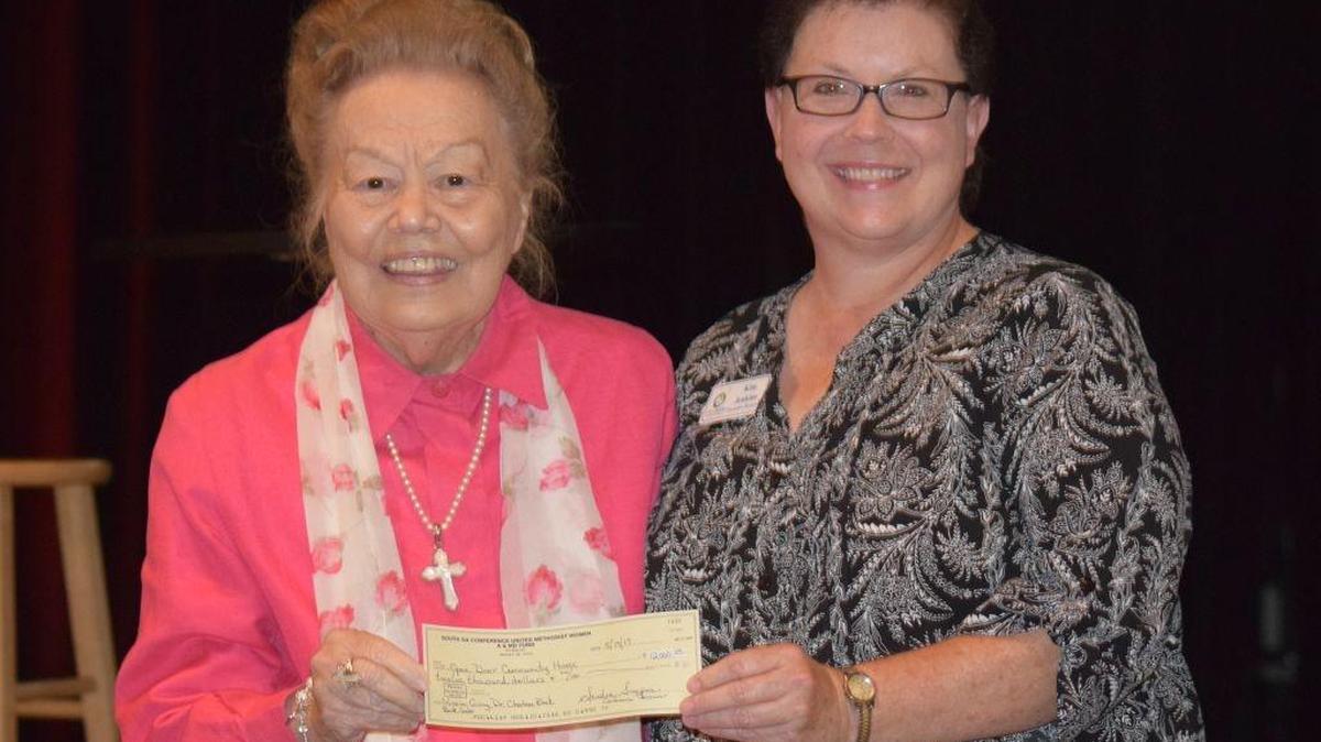 Charlene Black, left, gave check to Kim Jenkins of Open Door