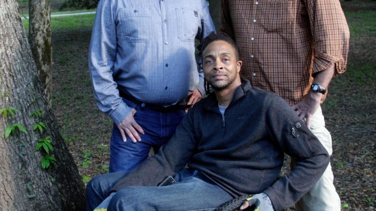 Chad Pepper, left, and Lee Griffith, right, are raising money to buy a special wheelchair for O’Ree Crittenden, a quadriplegic, to hike the Georgia section of the Appalachian Trail. A lifelong outdoor enthusiast, Crittenden, 43, broke his neck after jumping off a pier to retrieve a child's kite in the ocean during a trip to Pensacola, Fla., in 2001.