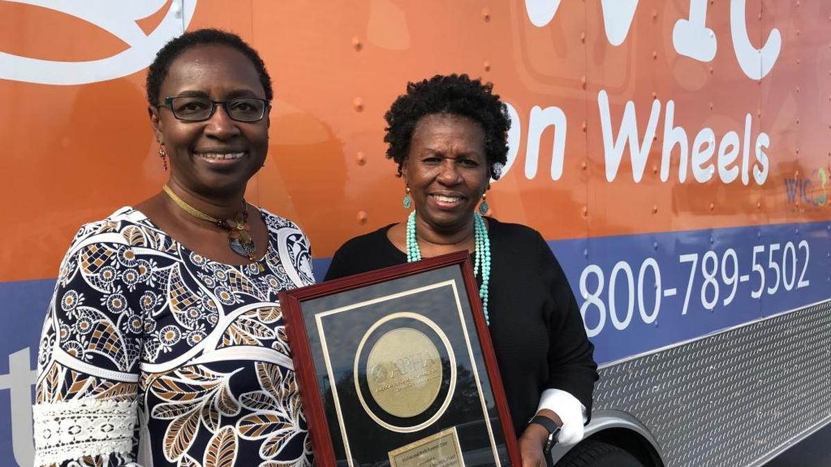 Dr. Beverley Townsend (left), Brenda Foreman show award