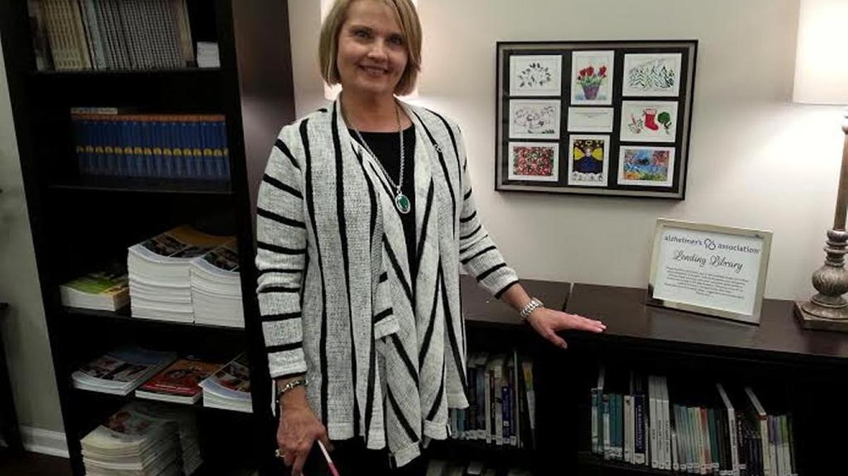 Jeannie Pierson shows off part of lending library.