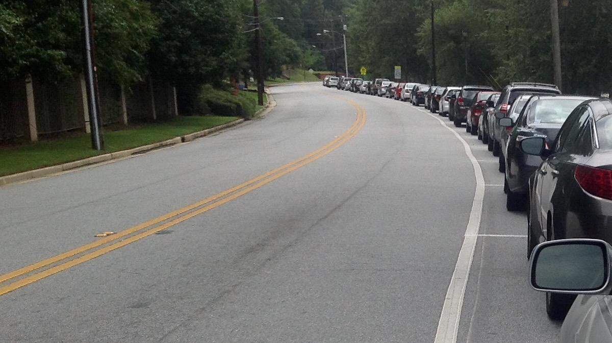 Cars line the east side of Weracoba Park between Garrard Street and 17th Street on Tuesday.