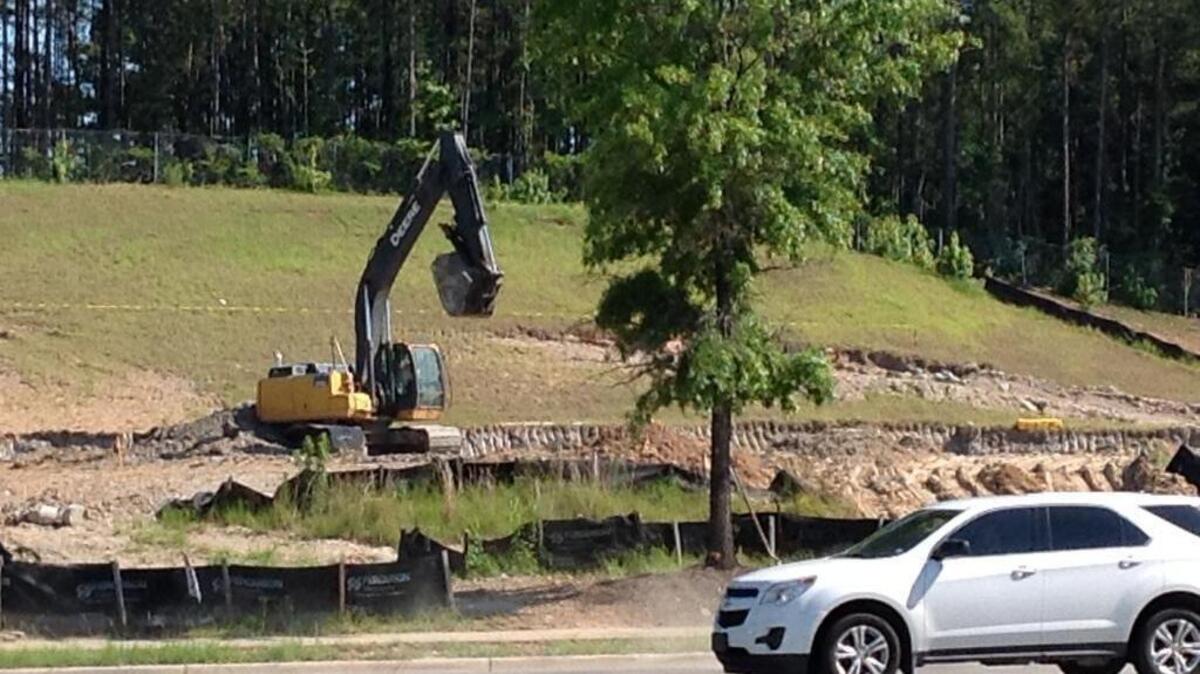 A motorist passes the site of a new convenience store in the early stages of construction and between Fazoli’s and Dairy Queen eateries on Whittlesey Boulevard at Columbus Park Crossing. An Old Chicago Pizza & Taproom is going on the land across from a new Academy Sports and Outdoors store. --