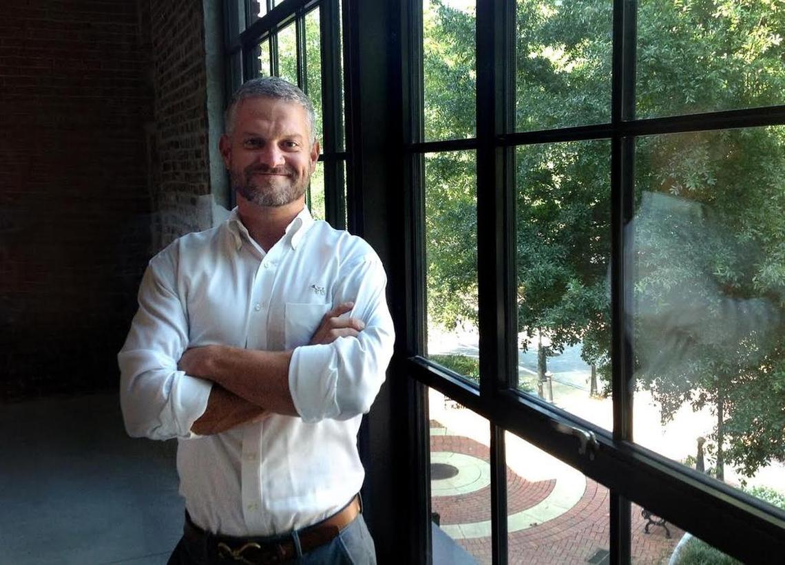 Columbus developer Chris Woodruff, president of the The Cotton Companies, stands in the window of the 1230 Broad building he has renovated.