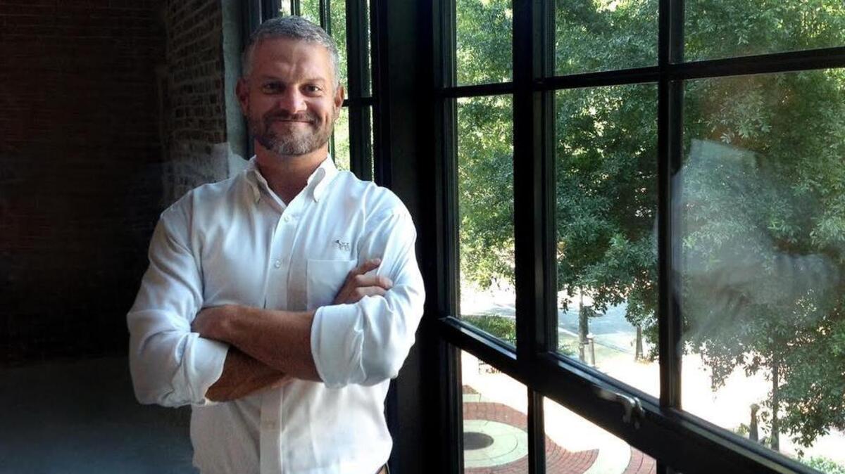 Columbus developer Chris Woodruff, president of the The Cotton Companies, stands in the window of the 1230 Broad building he has renovated.