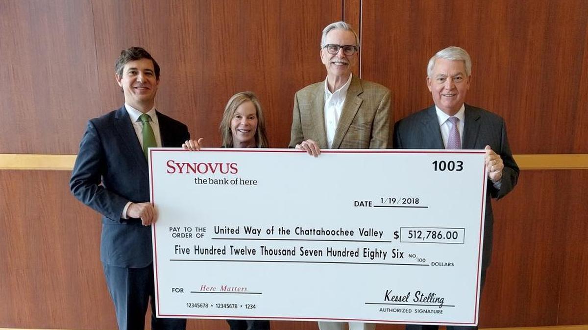 Shown during the check presentation Friday are, l-r, Heath Schondelmayer, president of the Synovus Bank division in Columbus; Becky Fletcher, United Way vice president of resource development; Scott Ferguson, local United Way president and CEO; and Kessel Stelling, Synovus chairman and chief executive officer. --