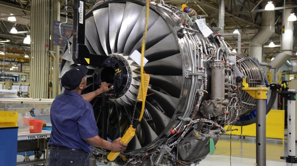 A mechanic works on a jet engine at the Pratt & Whitney plant in Columbus.