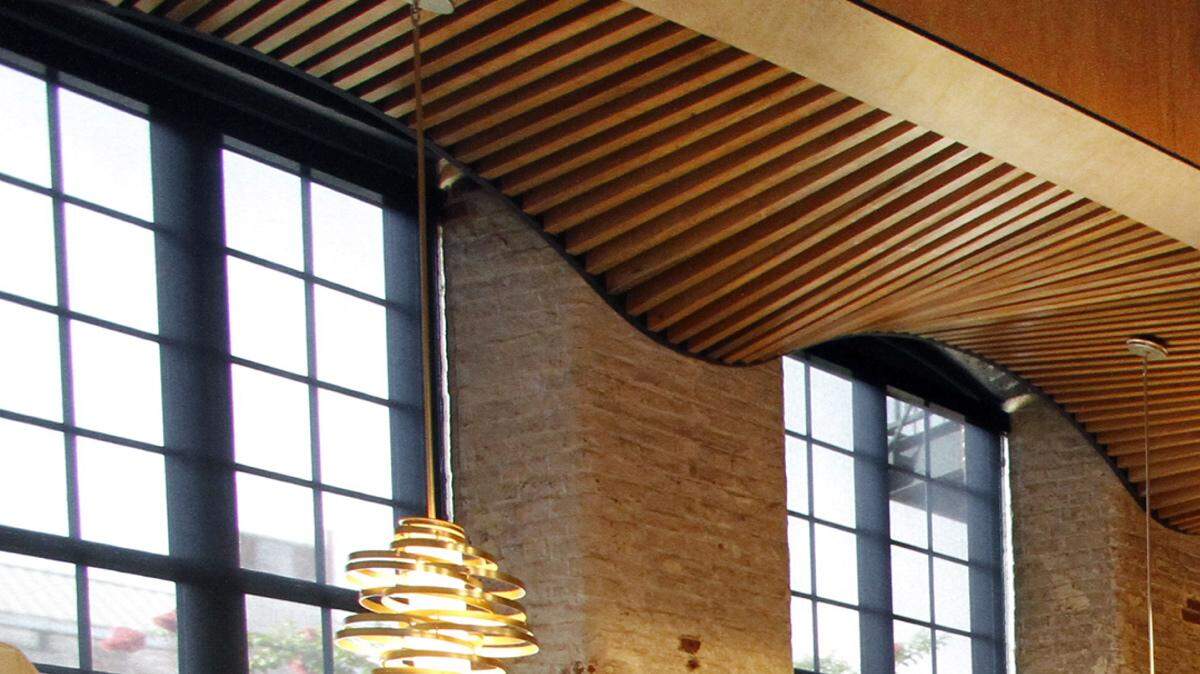 A waiter at Epic prepares the main dining room for the restaurant's grand opening event at the EAgle & Phenix Mill riverfront complex in 2012.