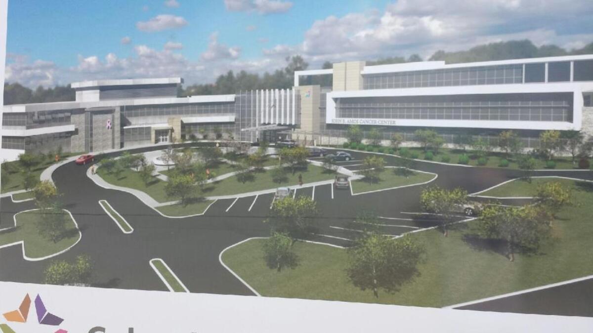 Here’s a job-site rendering of the John B. Amos Cancer Center with its future expansion that is now getting under way, nearly doubling the size of the facility. The rendering shows the new large building to the right, which is connected to the current building on the left. --
