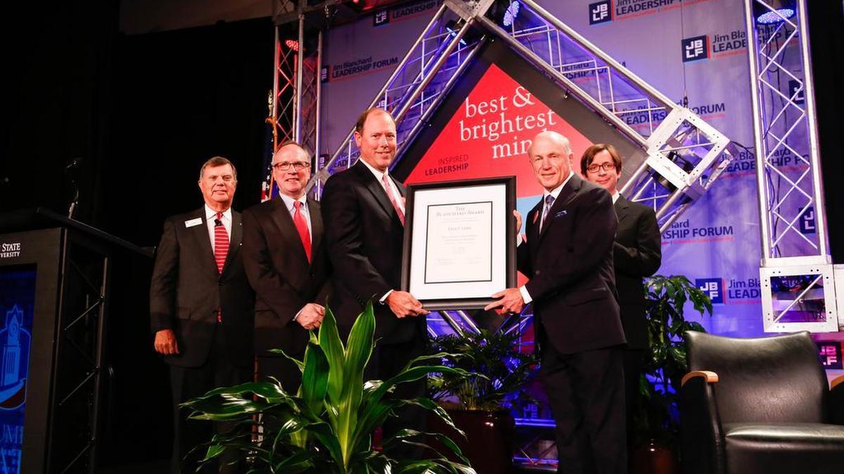 Billy Blanchard, director of JBA Capital LLC in Columbus, presents the Blanchard Award for Outstanding Stewardship and Ethics in Business to Dan Cathy (right), chairman and chief executive officer of Chick-fil-A, on Monday night during the Jim Blanchard Leadership Forum.