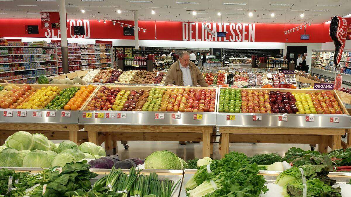 Shoppers at the remodeled Phenix City store pick up fruits and veggies Wednesday. An updated fresh produce department is one of the major improvements that Southeastern Grocers CEO Ian McLeod wanted to see in the Winn-Dixie stores operated by the company.