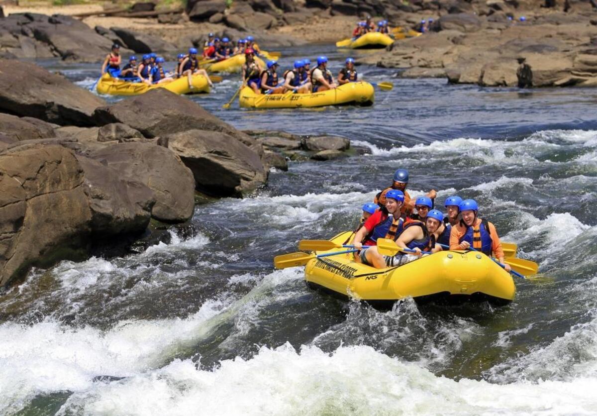 Rafters on a Whitewater Express trip brace themselves for the final set of rapids on the Chattahoochee Whitewater course as more rafters wait their turn. Whitewater Express is now offering season passes for purchase that allow unlimited rafting and zip-line trips for a full year.