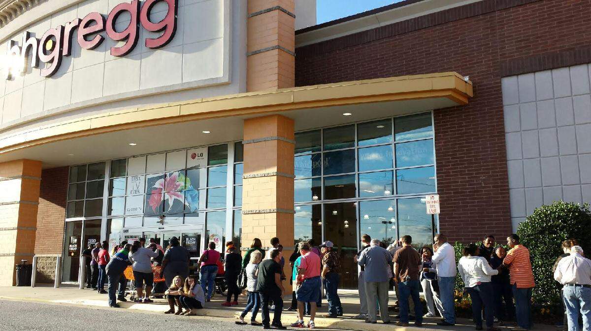 Shoppers gather in front of the hhgregg store at Columbus Park Crossing Thursday, a crowd that included Jonathan Joseph and Spencer Jones, first in line and both of Fort Benning. Joseph was planning to purchase a 55-inch Seiki LED television for $298 to replace his existing 14-inch TV.