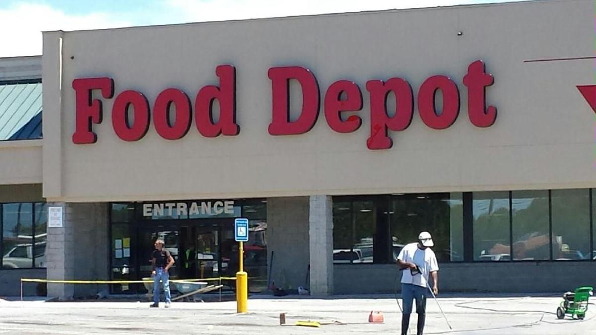 Workers prepare the Food Depot store for its opening at Manchester Square shopping center, 5600 Milgen Road, in Columbus. The company hopes to open the nearly 48,000-square-foot traditional grocery store by July 11. /