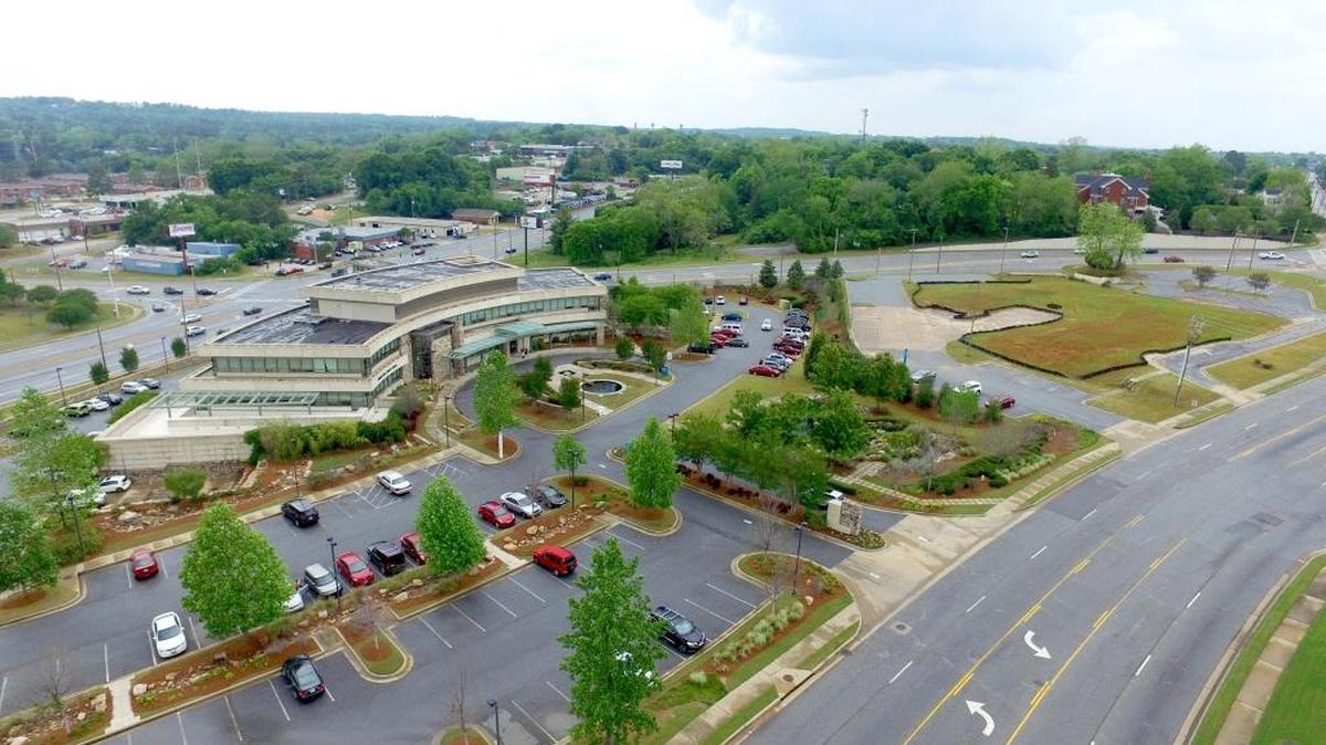 This aerial shot supplied by Columbus Regional Health shows the John B. Amos Cancer Center, which opened in 2004, and adjacent land to the right that will be used to nearly double the size of the center. The construction cost alone is nearly $15.8 million for the 46,411-square-foot expansion of the facility. The former Hamilton House nursing home is the property upon which the project will occur. --