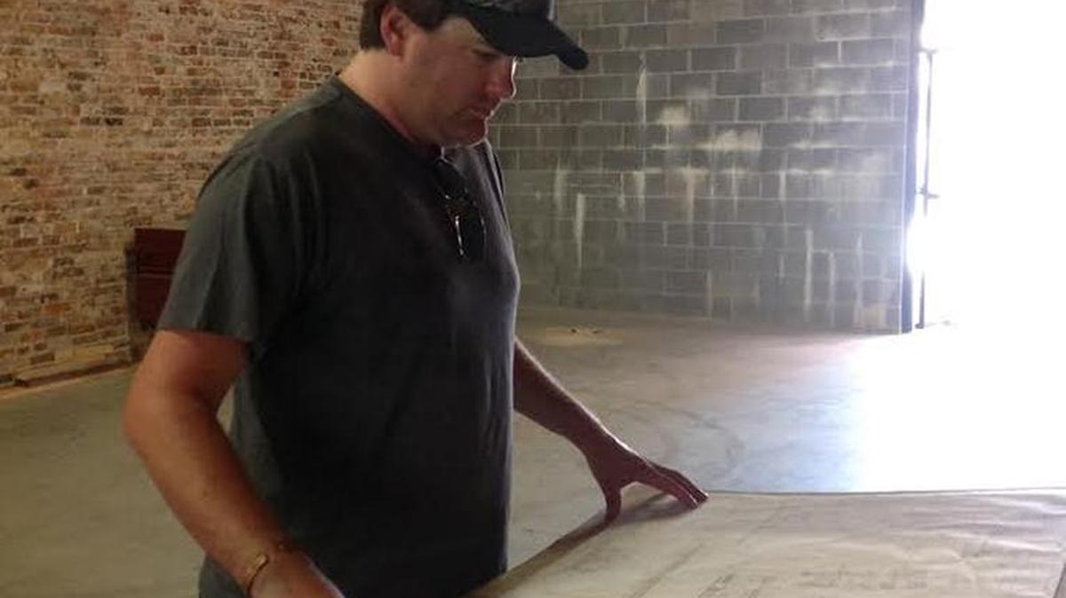 Frank Foley IV looks over plans this week for new downtown Columbus restaurant at 1232 Broadway.