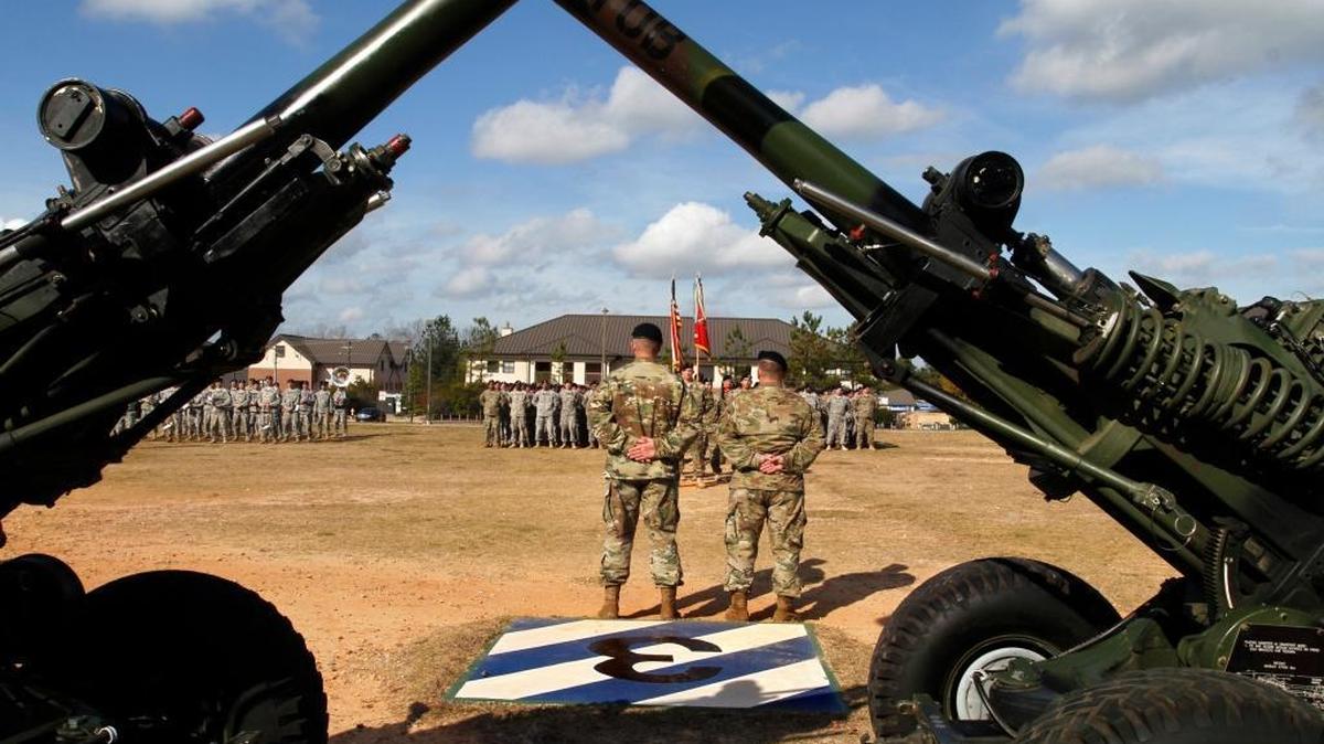 Two M-119A-3 Towed Howitzer guns frame the Inactivation Ceremony for the 1st Battalion, 10th Field Artillery Regiment, 3rd Brigade Combat Team, 3rd Infantry Division on Kelley Hill in December. The 600-soldier battalion is the first of five 3rd Brigade battalions that will deactivate by the spring of 2016 as part of the overall U.S. Army troop reduction.