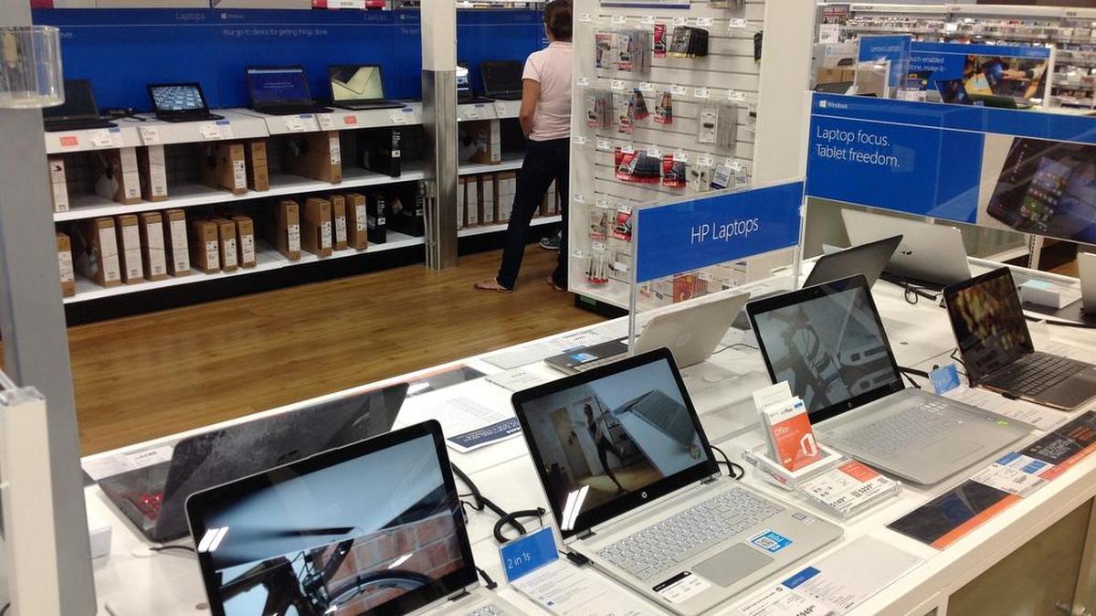 A shopper peruses a laptop computer aisle at the Columbus Best Buy store earlier this year. Laptops, 4K high-definition TVs, video game stations, cameras, iPad devices and appliances will be among the Black Friday (and Thanksgiving Day) deals offered by the retailer. --