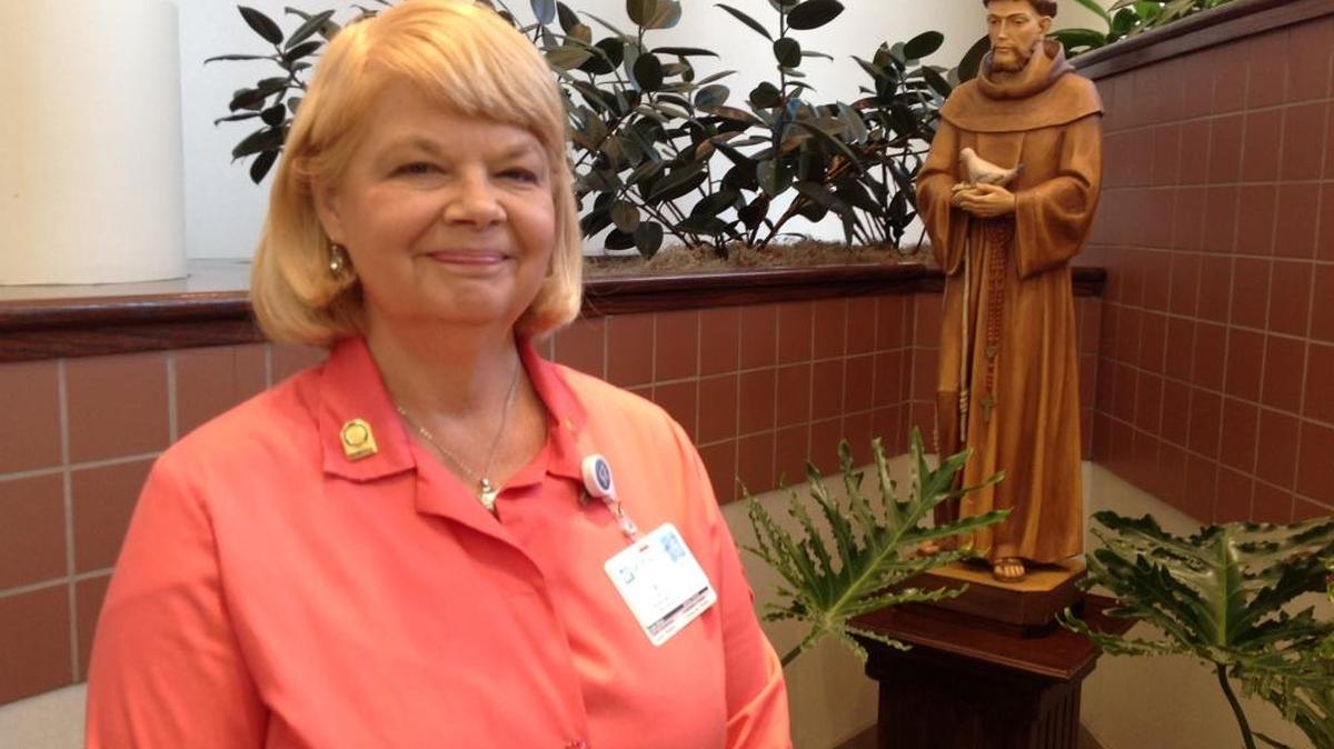 Retired Hardaway High School teacher Wendy Harding is now a volunteer at St. Francis Hospital in Columbus, among many other places through the years. Here she stands near the Saint Francis of Assisi statue outside the hospital’s chapel. --