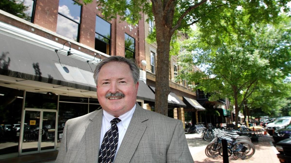 Neil Clark, architect and partner with Hecht Burdeshaw Architects, stands outside the renovated Iron Bank building at the corner of Broadway and 11th Street.