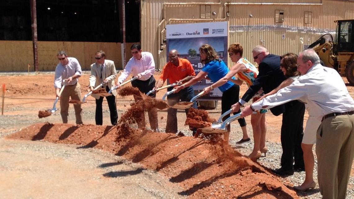 Performing the ceremonial breaking of ground Monday at the Char-Broil office construction site on Belfast Avenue are, left to right, Wes Kelly, vice president and division manager with Brasfield & Gorrie; Scott Allen, senior principal at 2WR+ Partners; Russ Carreker, chairman of the Development Authority of Columbus; Linnen Brown, a 36-year employee and material handler at Char-Broil; Lana Tuning, a 27-year employee and warranty operations manager at Char-Broil; Chris Robins, chief executive officer of Char-Broil; Marc Olivié, CEO of W.C. Bradley Co.; Columbus Mayor Teresa Tomlinson; and W.C. Bradley Chairman Steve Butler.