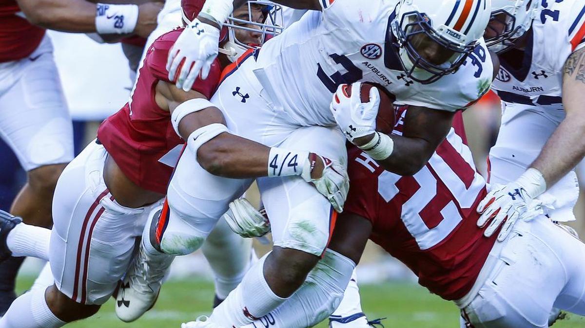 Auburn running back Kamryn Pettway carries the ball during the 2016 edition of the Iron Bowl in Tuscaloosa, Ala. The Tide won 30-12 a year ago, but is only a slight favorite for Saturday's Iron Bowl in Auburn, Ala. The winner will take on the Georgia Bulldogs in the SEC Championship game Dec. 2 in Atlanta. --