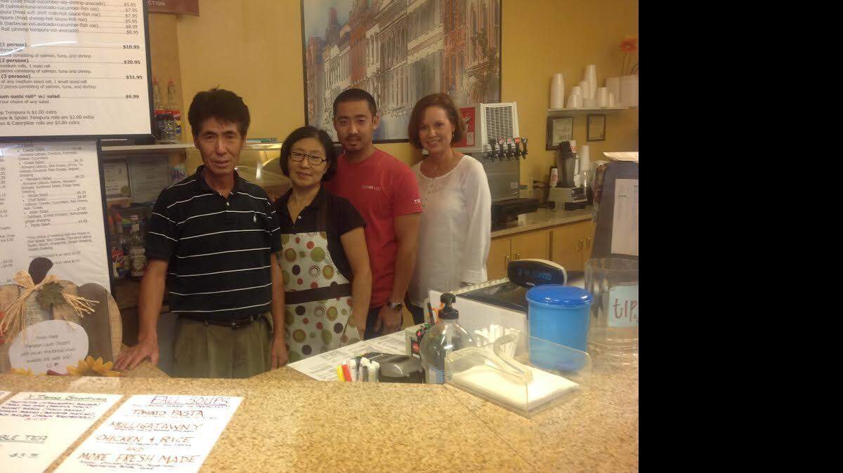 Chong and Kwang Kim, owners of Jumpin Java on Whittlesey Road, spend an afternoon at the restaurant with son, Alfred, and customer, Eileen Barrs.