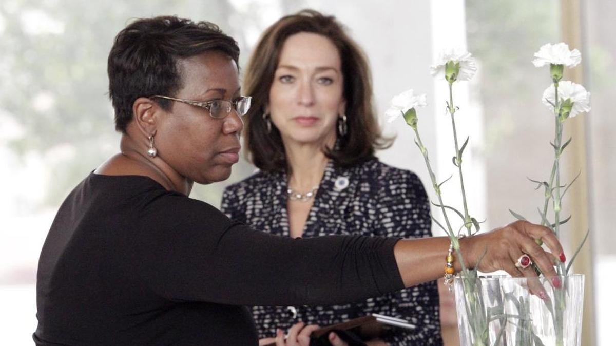 Lisa Goodwin, left, and former Mayor Teresa Tomlinson, right, participate in a Columbus Consolidated Government employee memorial in 2016.