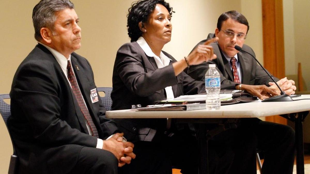 Democratic candidate Pam Brown, center, could be disqualified, along with fellow challenger Robert Smith, from seeking the office held by Sheriff John Darr, right. Pictured at the left is Republican challenger Mark LaJoye.
