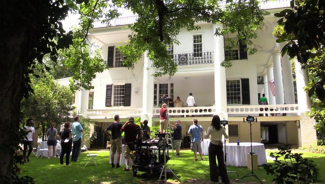 Cast and crew members of “Things Don’t Stay Fixed” prepare for a scene at the historic St. Elmo house in Columbus on June 19, 2017. Bo Bartlett is directing the film and shooting at several locations around Columbus. 