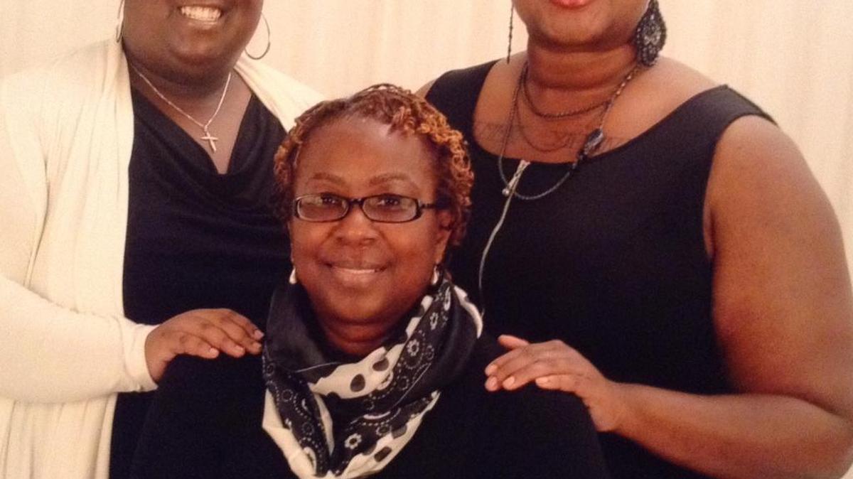 LaKalia Woods, left, is now home recovering from a flesh-eating bacteria infection. Her mother, Rachelle, seated, and sister, Jasmine, to the right, met Aimee Copeland, another survivor of necrotizing fasciitis, at a United Way Power of the Purse luncheon, where Copeland shared her inspirational story.